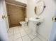 Updated bathroom with pedestal sink, shower stall and tile flooring at 809 Florida Pkwy, Kissimmee, FL 34743