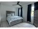 Bright bedroom with gray platform bed and dark blue curtains at 809 Florida Pkwy, Kissimmee, FL 34743