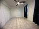Well-lit bedroom with double door closet and tile flooring at 809 Florida Pkwy, Kissimmee, FL 34743