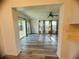 Bright Gathering room featuring wood-look floors and sliding glass doors leading to the backyard at 809 Florida Pkwy, Kissimmee, FL 34743