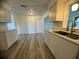Renovated kitchen boasts modern white cabinets and new stainless steel sink at 809 Florida Pkwy, Kissimmee, FL 34743