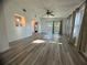 Spacious living room with wood-look floors and access to backyard at 809 Florida Pkwy, Kissimmee, FL 34743