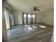 Spacious living room with wood-look floors, ceiling fan and backyard access at 809 Florida Pkwy, Kissimmee, FL 34743