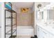 Bathroom with double vanity, bathtub, and modern tile at 150 E Robinson St # 1709, Orlando, FL 32801
