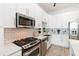 Modern kitchen with stainless steel appliances and white cabinets at 150 E Robinson St # 1709, Orlando, FL 32801