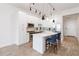 Modern kitchen with white cabinets, island, and stainless steel appliances at 150 E Robinson St # 1709, Orlando, FL 32801