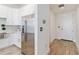 Modern kitchen entry with stainless steel fridge and white cabinets at 150 E Robinson St # 1709, Orlando, FL 32801