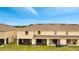 Rear view of house with screened patio and AC units at 200 Feltrim Reserve Blvd, Davenport, FL 33837