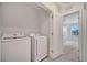 Bright laundry room with washer and dryer in a closet at 200 Feltrim Reserve Blvd, Davenport, FL 33837