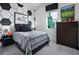 Bedroom with soccer themed decor, accent wall with hexagon pattern, plaid bedding, and a window at 1559 Gardiner St, Haines City, FL 33844