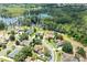 Aerial view of a neighborhood showcasing the property's proximity to a serene lake and lush greenery at 11602 Graces Way, Clermont, FL 34711