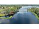 Scenic aerial view of the property location with direct access to a beautiful lake and lush greenery all around at 11602 Graces Way, Clermont, FL 34711