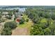 Overhead view of a property with a spacious backyard and access to a lake surrounded by trees and greenery at 11602 Graces Way, Clermont, FL 34711