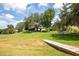 Expansive backyard with mature trees leads to a tranquil lakefront and private dock at 11602 Graces Way, Clermont, FL 34711