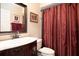 Bathroom featuring a single sink vanity, toilet, and a shower with a decorative curtain at 11602 Graces Way, Clermont, FL 34711
