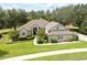 Inviting single-Gathering home with a manicured lawn, beautiful landscaping, and a welcoming entrance at 11602 Graces Way, Clermont, FL 34711