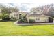 Charming home with a well-manicured lawn, lush landscaping and a brick walkway leading to the entrance at 11602 Graces Way, Clermont, FL 34711