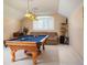 Spacious game room featuring a pool table, comfortable seating, and natural light at 11602 Graces Way, Clermont, FL 34711