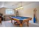 Spacious game room features a billiard table, overhead lights, and comfortable seating at 11602 Graces Way, Clermont, FL 34711