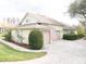 Home featuring a three-car garage, paved driveway and mature landscaping at 11602 Graces Way, Clermont, FL 34711