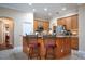 Charming kitchen with an island bar, wood cabinetry, and stainless steel appliances at 11602 Graces Way, Clermont, FL 34711