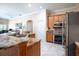 Kitchen featuring granite counters, stainless appliances and oak cabinets at 11602 Graces Way, Clermont, FL 34711