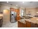 Open kitchen featuring a large island, stainless steel appliances, and granite countertops at 11602 Graces Way, Clermont, FL 34711