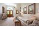 Bright living room with neutral carpet, glass sliding doors, and plenty of space for entertaining guests at 11602 Graces Way, Clermont, FL 34711