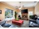 Inviting living room with a stone fireplace, access to the screened patio, and natural light at 11602 Graces Way, Clermont, FL 34711