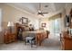 Spacious main bedroom with tray ceiling, ceiling fan, and sliding glass doors to the outside at 11602 Graces Way, Clermont, FL 34711