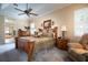 Bright main bedroom with a decorative ceiling fan, crown molding, and well-placed furniture at 11602 Graces Way, Clermont, FL 34711