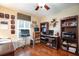 Bright office with hardwood floors, built-in bookshelves, and a computer workstation at 11602 Graces Way, Clermont, FL 34711