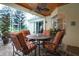 Covered screened patio with a stone floor, ceiling fan, and outdoor seating area at 11602 Graces Way, Clermont, FL 34711