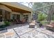 Screened-in patio featuring stone flooring, ceiling fan, and comfortable seating area at 11602 Graces Way, Clermont, FL 34711