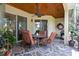 Covered outdoor patio with a ceiling fan, outdoor seating, and a view of the backyard at 11602 Graces Way, Clermont, FL 34711