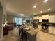 Modern kitchen features granite countertops, stainless steel appliances and island at 5242 Wildwood Way, Davenport, FL 33837