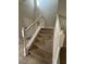 Clean, carpeted staircase with white railings leading to the second floor at 5242 Wildwood Way, Davenport, FL 33837