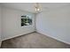 Bedroom with neutral decor, carpet flooring, and large window at 340 Troon Cir, Davenport, FL 33897