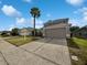 Two-story house with attached garage and landscaped lawn at 340 Troon Cir, Davenport, FL 33897