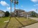 Two-story house with attached garage and landscaped lawn at 340 Troon Cir, Davenport, FL 33897