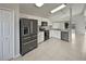 Modern kitchen with stainless steel appliances and white cabinets at 340 Troon Cir, Davenport, FL 33897