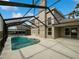 Large screened-in pool area with spacious patio at 340 Troon Cir, Davenport, FL 33897