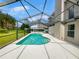 Relaxing kidney-shaped pool with screened enclosure at 340 Troon Cir, Davenport, FL 33897