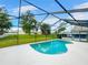 Kidney-shaped pool with screened enclosure at 340 Troon Cir, Davenport, FL 33897