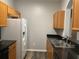 Kitchen features wood cabinets, granite countertops, and stainless steel appliances at 6100 Stevenson Dr # 207, Orlando, FL 32835