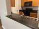 Kitchen boasts granite countertops and a pass-through to the living area at 6100 Stevenson Dr # 207, Orlando, FL 32835