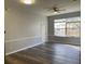 Spacious living room with wood-look floors and large windows at 6100 Stevenson Dr # 207, Orlando, FL 32835