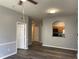 Open living room featuring a kitchen pass-through and wood-look floors at 6100 Stevenson Dr # 207, Orlando, FL 32835