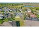 Aerial view of backyard featuring green grass and a home with screened-in pool at 2855 Gopherwood Way, Clermont, FL 34711