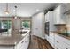 Modern kitchen with granite countertops, stainless steel appliances, and white cabinetry at 30215 Bretton Loop, Mount Dora, FL 32757